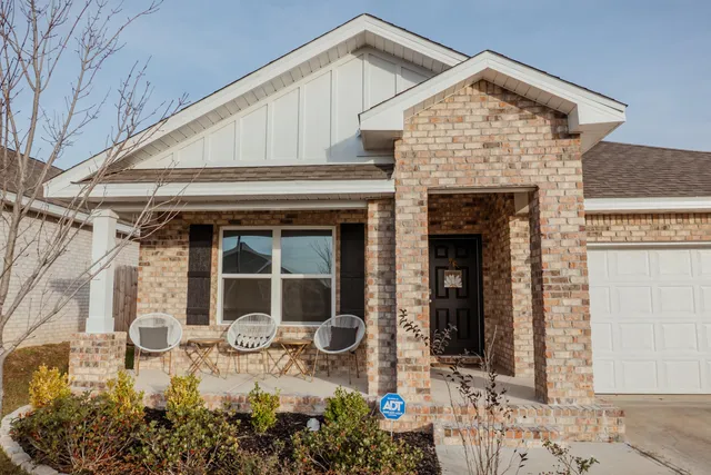a view of a house with chair in front of house