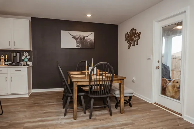 a view of a dining room with furniture and wooden floor