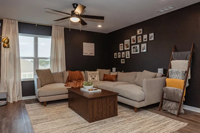 a living room with furniture and a large window