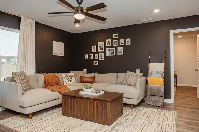 a living room with furniture and a rug