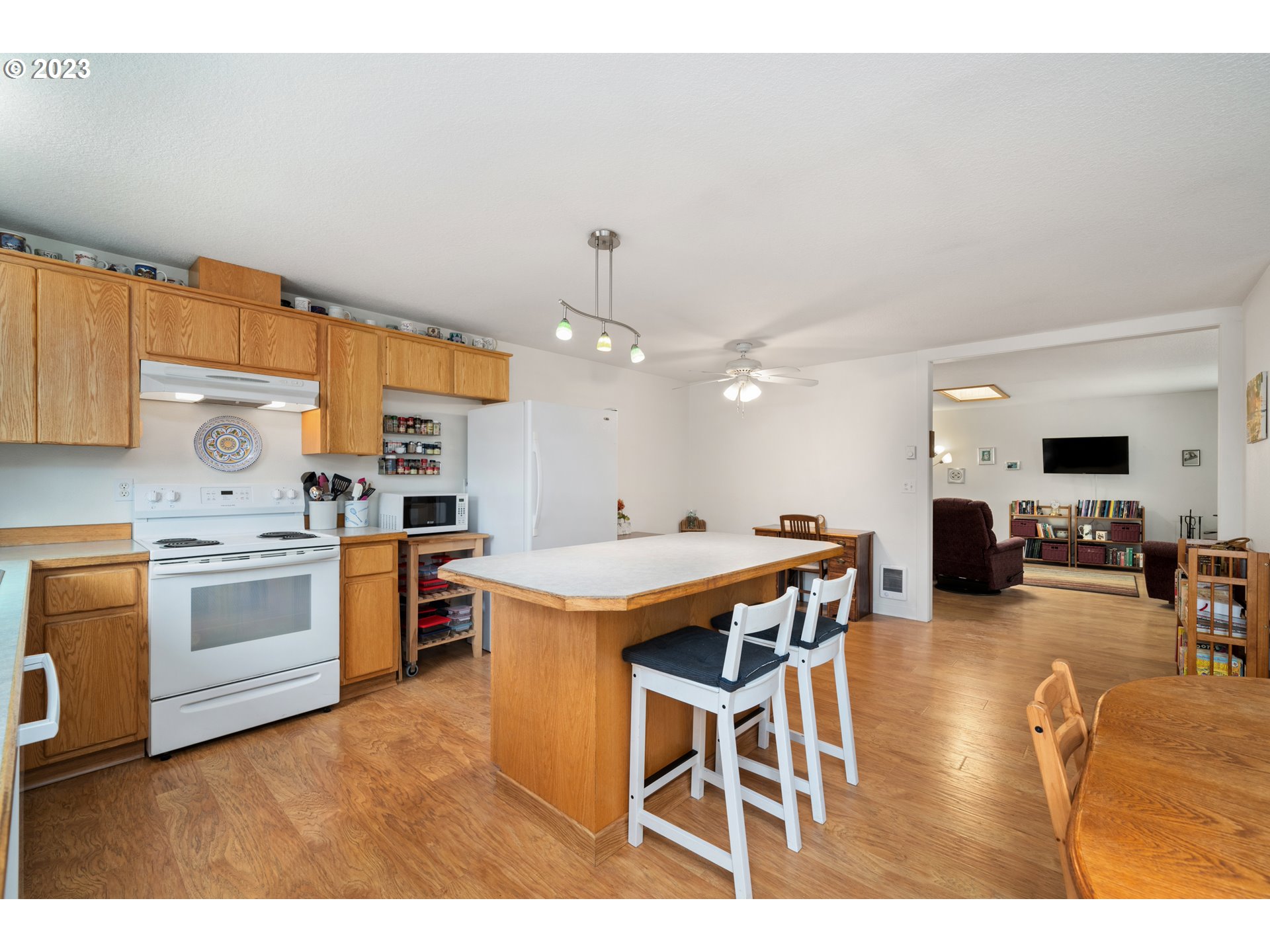 34100 Pintail Avenue Nehalem, OR 97131 - Photo 11 of 31 a open kitchen with stainless steel appliances kitchen island granite countertop a table chairs sink and cabinets