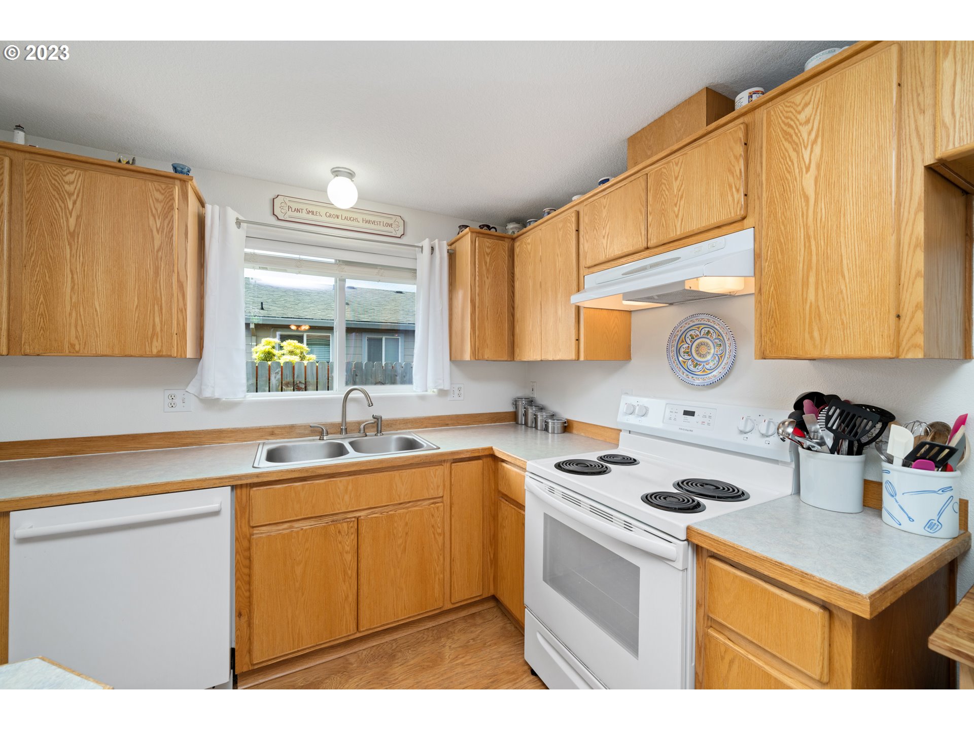 34100 Pintail Avenue Nehalem, OR 97131 - Photo 14 of 31 a kitchen with a sink stove top oven and cabinets