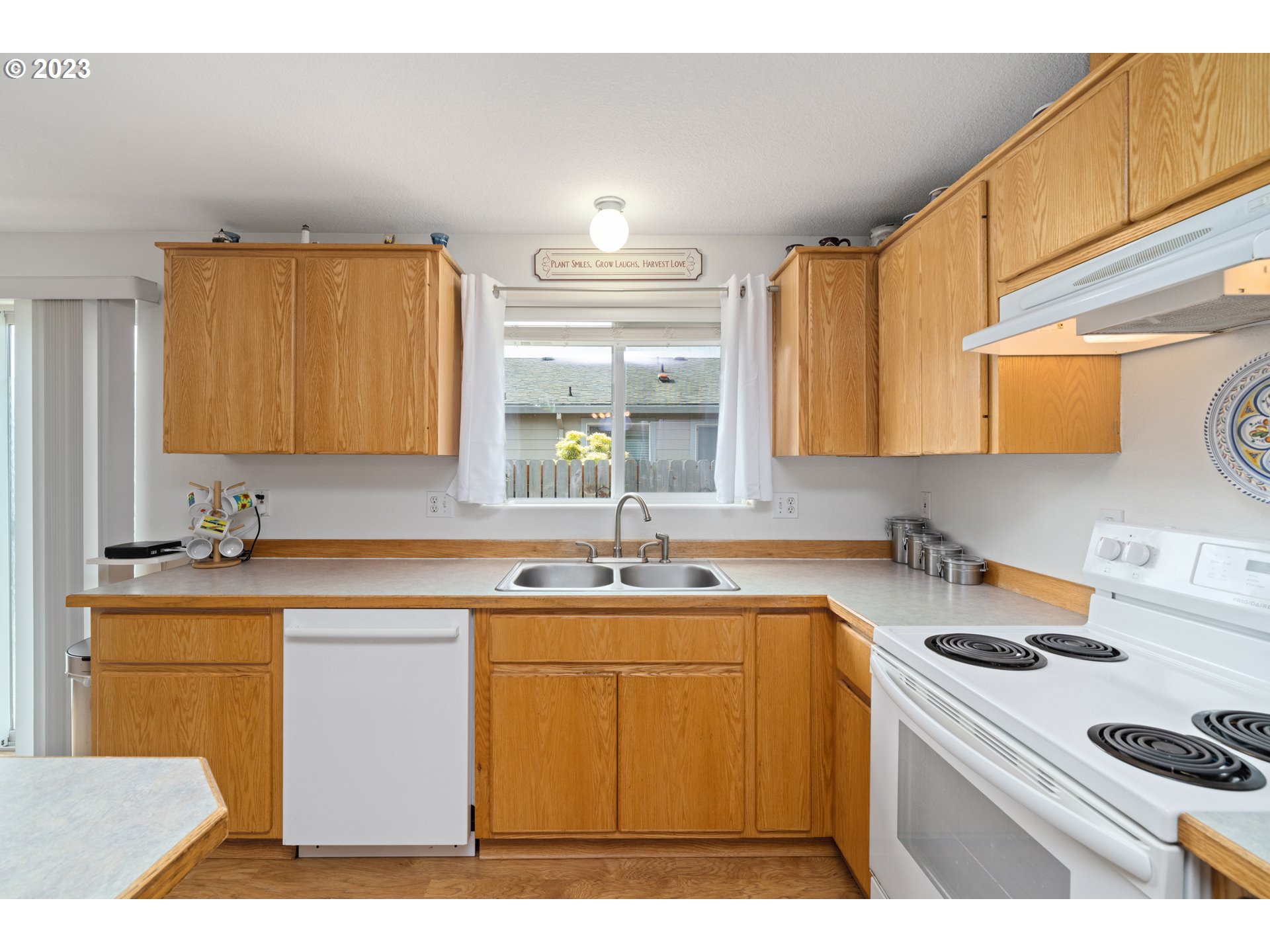 34100 Pintail Avenue Nehalem, OR 97131 - Photo 15 of 31 a kitchen with a sink a stove and cabinets