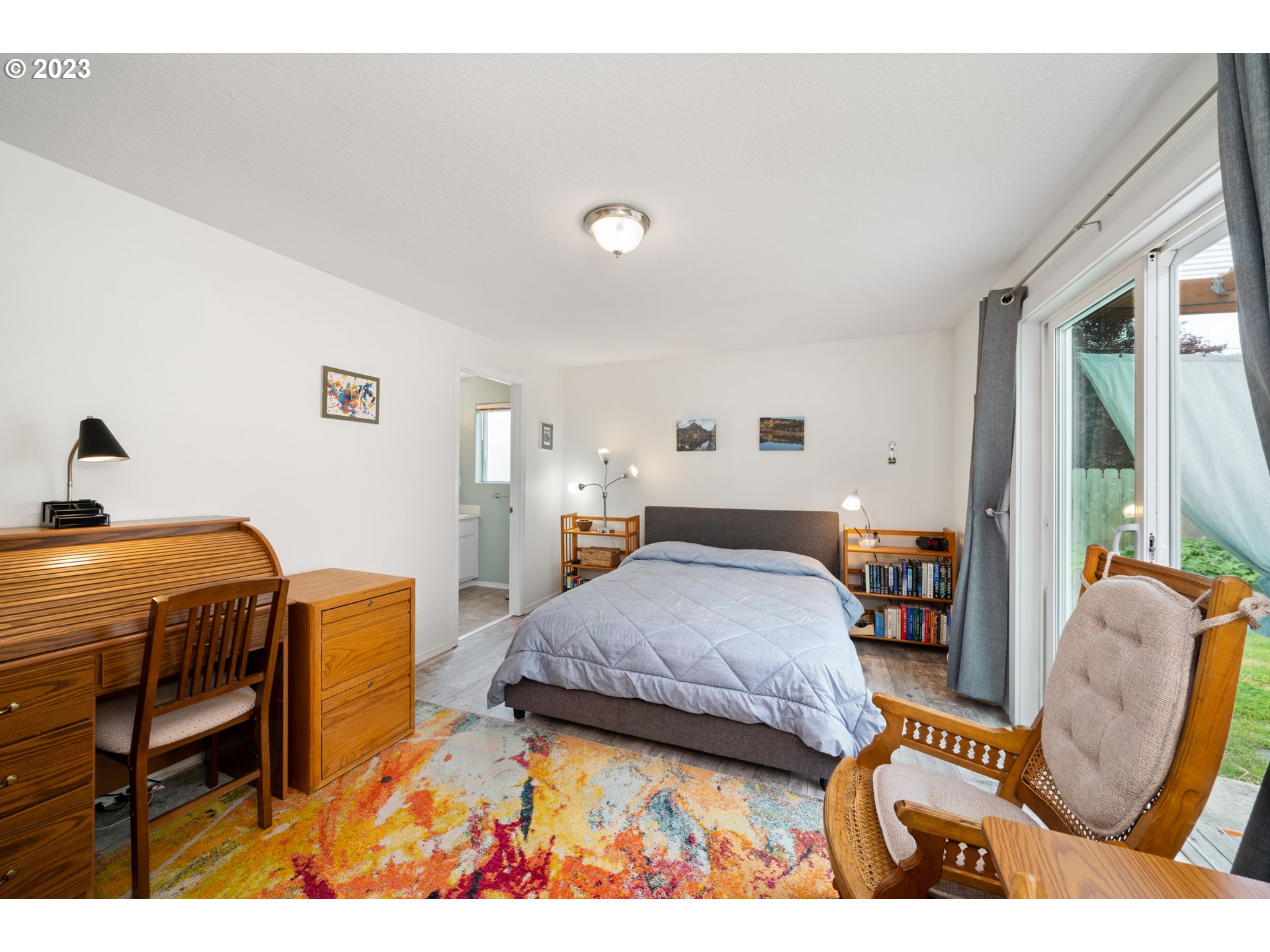 34100 Pintail Avenue Nehalem, OR 97131 - Photo 17 of 31 a bedroom with a bed and wooden floor