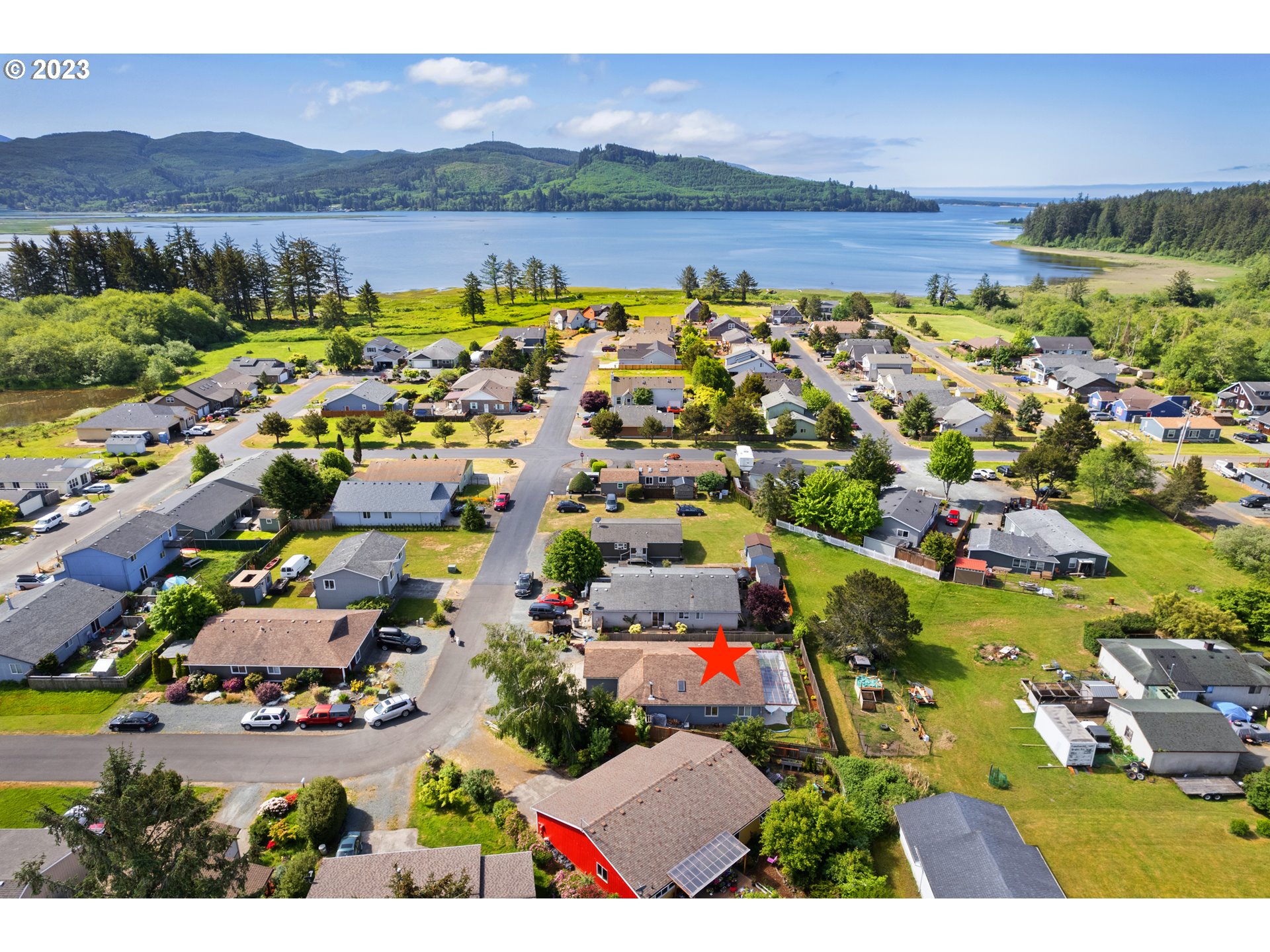 34100 Pintail Avenue Nehalem, OR 97131 - Photo 2 of 31 an aerial view of residential houses with outdoor space and lake view
