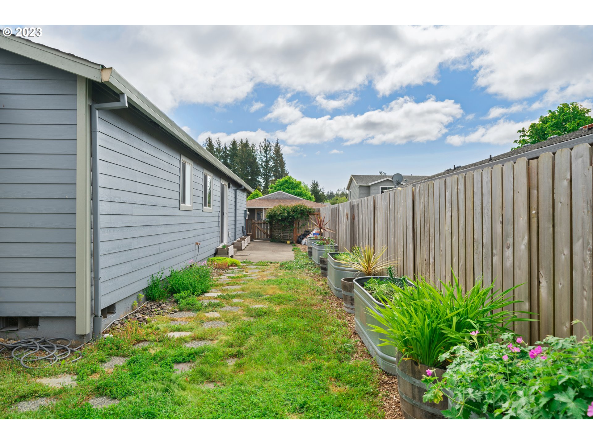 34100 Pintail Avenue Nehalem, OR 97131 - Photo 26 of 31 a backyard of a house with lots of green space