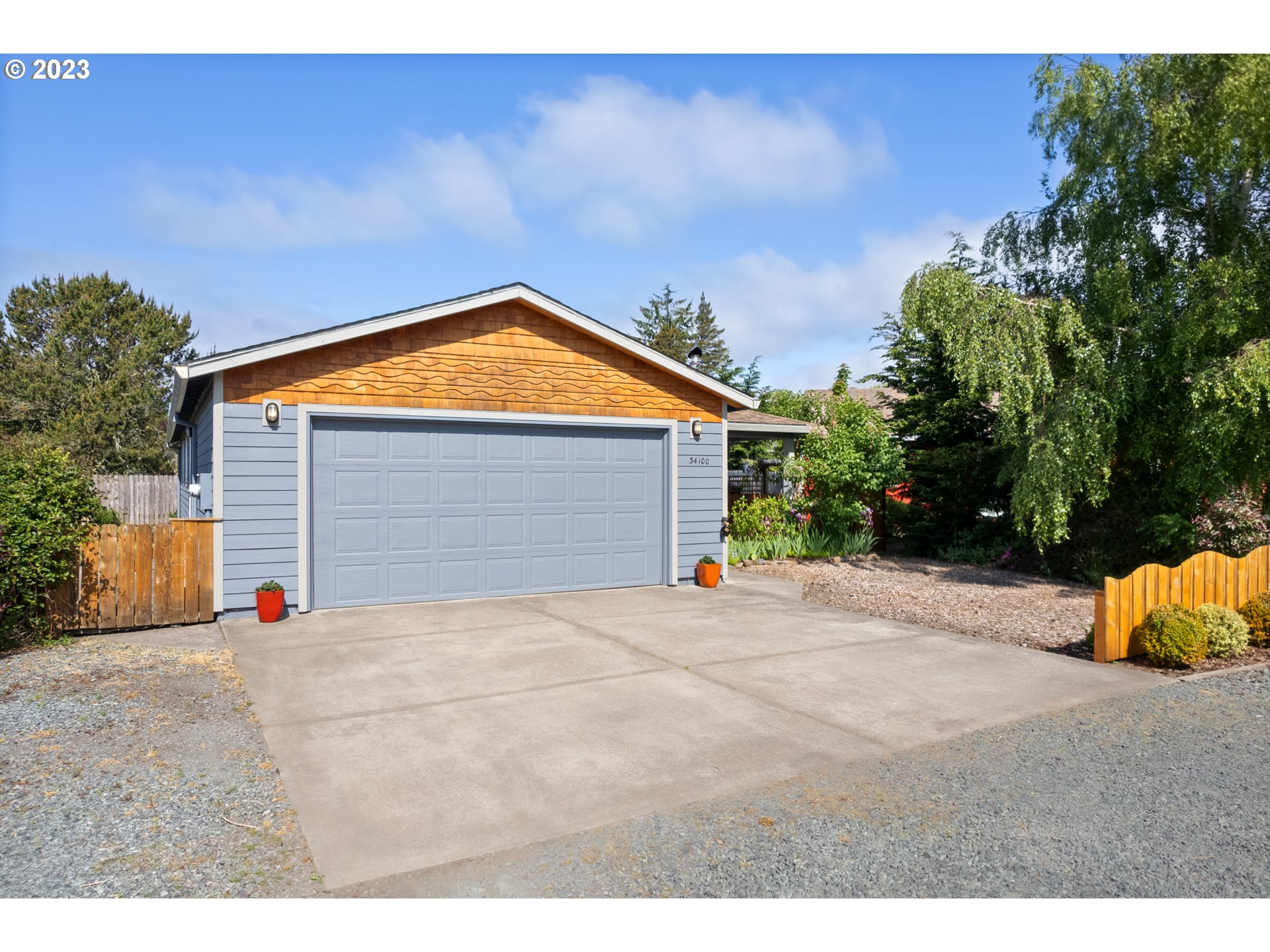 34100 Pintail Avenue Nehalem, OR 97131 - Photo 27 of 31 a backyard of a house with yard and garage