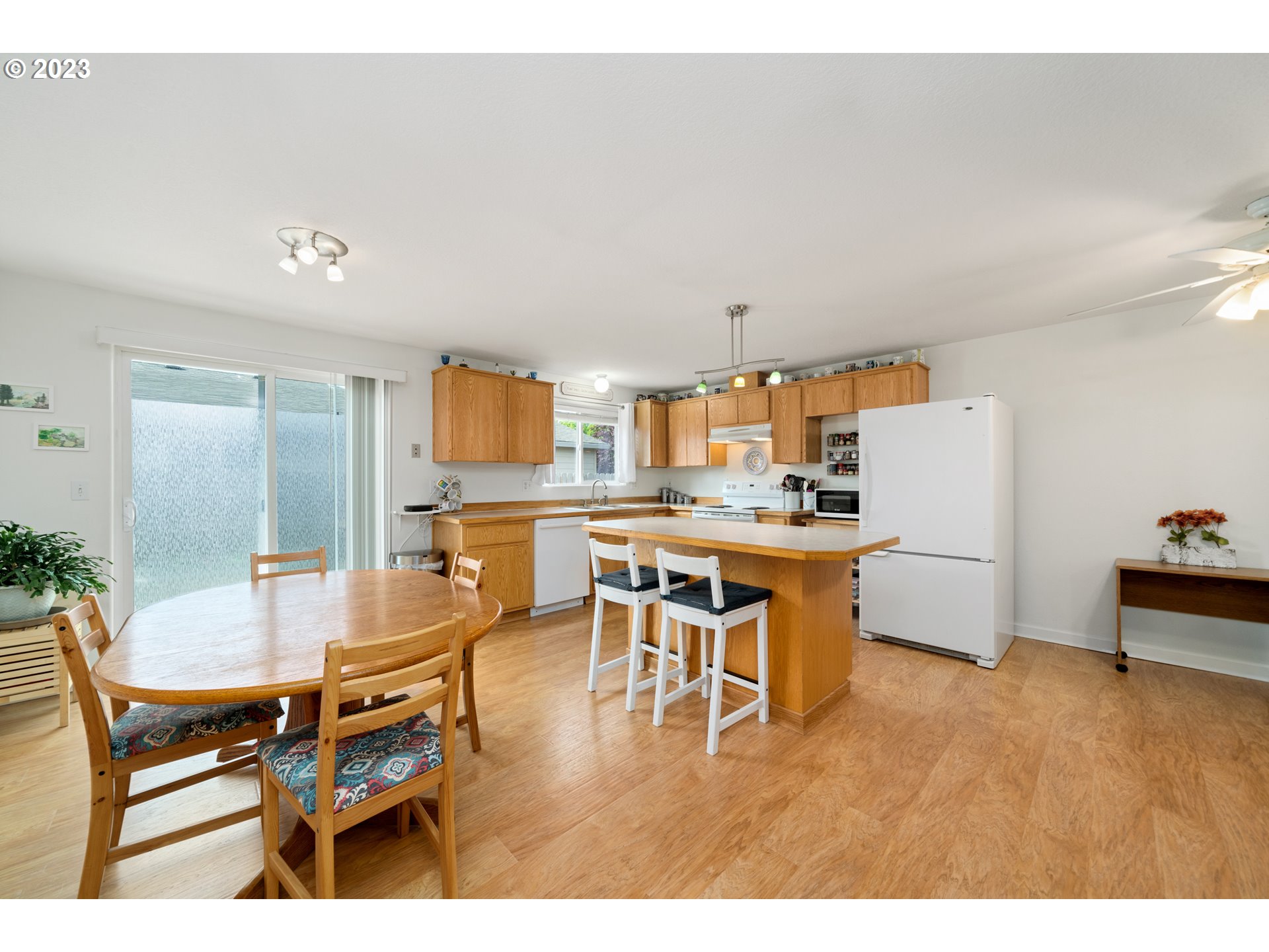 34100 Pintail Avenue Nehalem, OR 97131 - Photo 10 of 31 a kitchen with a dining table chairs and white appliances