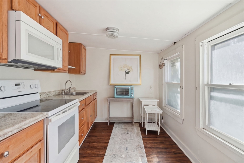 1080 Shirley Street Winthrop, MA 02152 - Photo 12 of 21 a kitchen with a sink stove and refrigerator