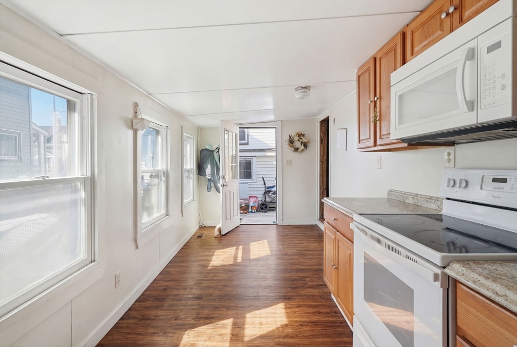 1080 Shirley Street Winthrop, MA 02152 - Photo 13 of 21 a kitchen with granite countertop a refrigerator and a stove top oven