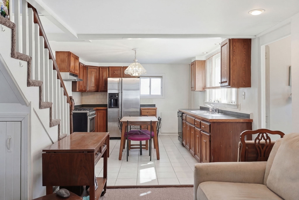1080 Shirley Street Winthrop, MA 02152 - Photo 3 of 21 a living room with stainless steel appliances kitchen island granite countertop furniture a refrigerator a sink a stove top oven a dining table and chairs