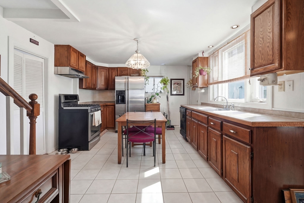 1080 Shirley Street Winthrop, MA 02152 - Photo 4 of 21 a kitchen with stainless steel appliances granite countertop a sink and a refrigerator