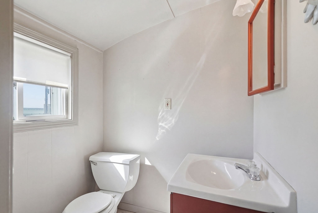 1080 Shirley Street Winthrop, MA 02152 - Photo 7 of 21 a white toilet sitting next to a bathroom sink