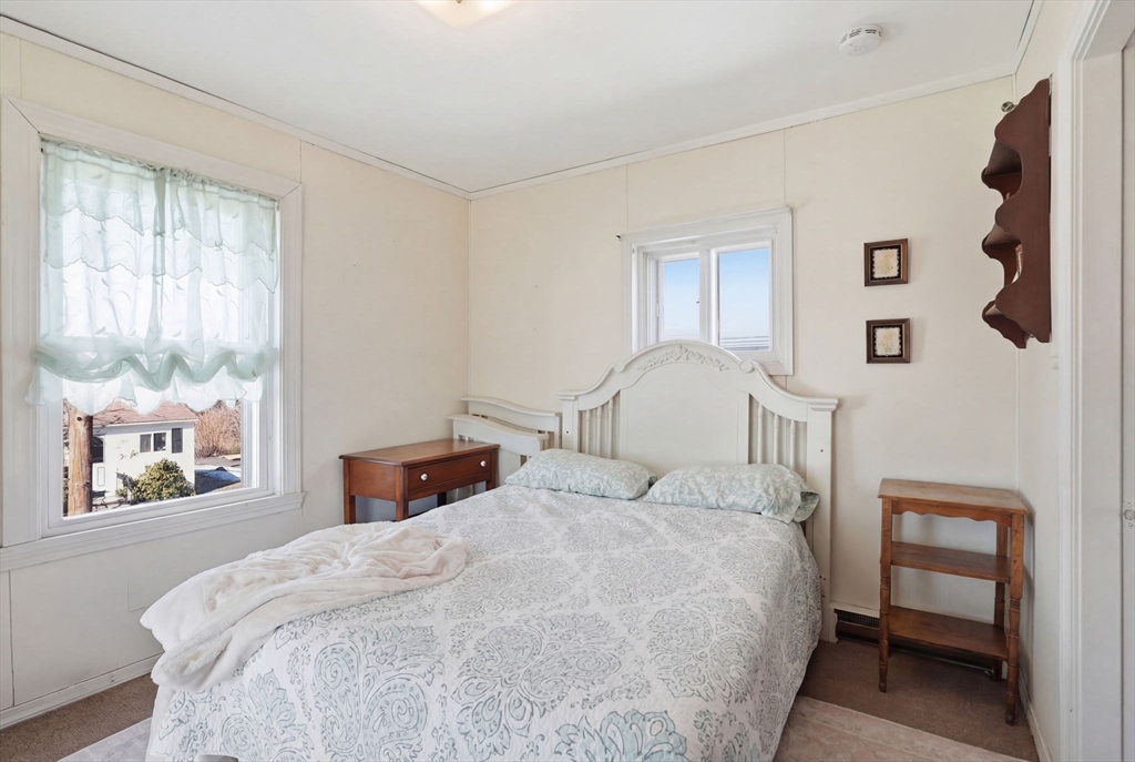 1080 Shirley Street Winthrop, MA 02152 - Photo 9 of 21 a bedroom with a bed and a window
