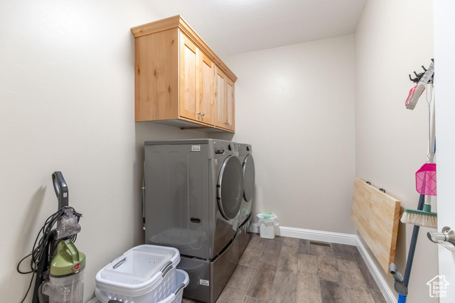 19502 South Olson Road Downey, ID 83234 - Photo 27 of 64 Washroom with wood finished floors, washing machine and dryer, and cabinet space