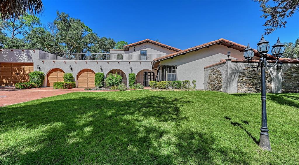 4674 Hidden River Road Sarasota, FL 34240 - Photo 1 of 46 a view of a house with a yard