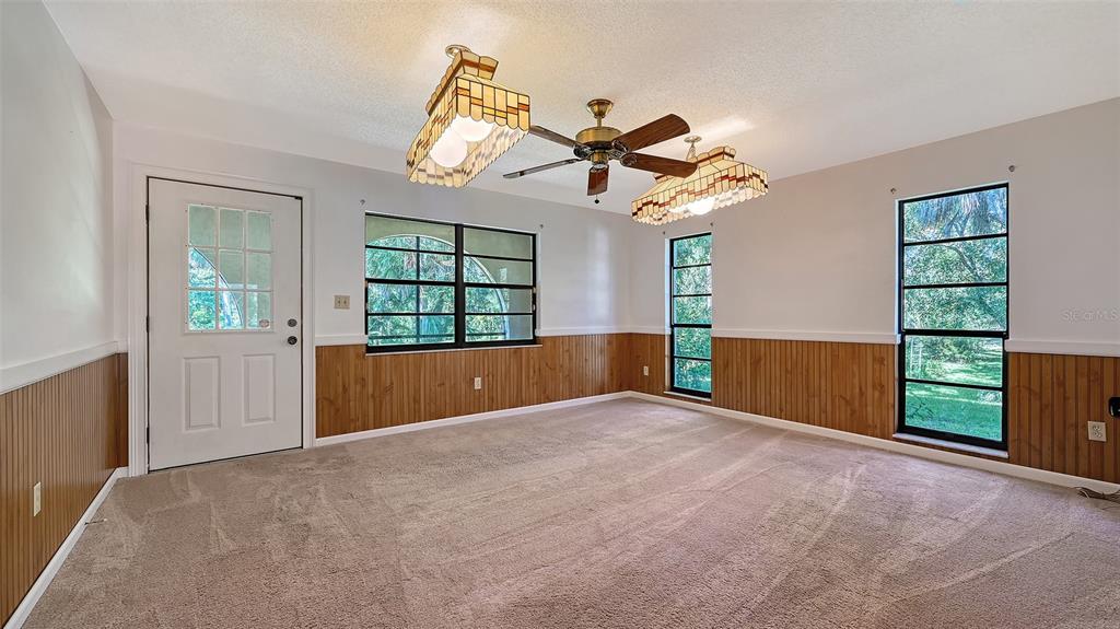 4674 Hidden River Road Sarasota, FL 34240 - Photo 12 of 46 an empty room with windows and fan