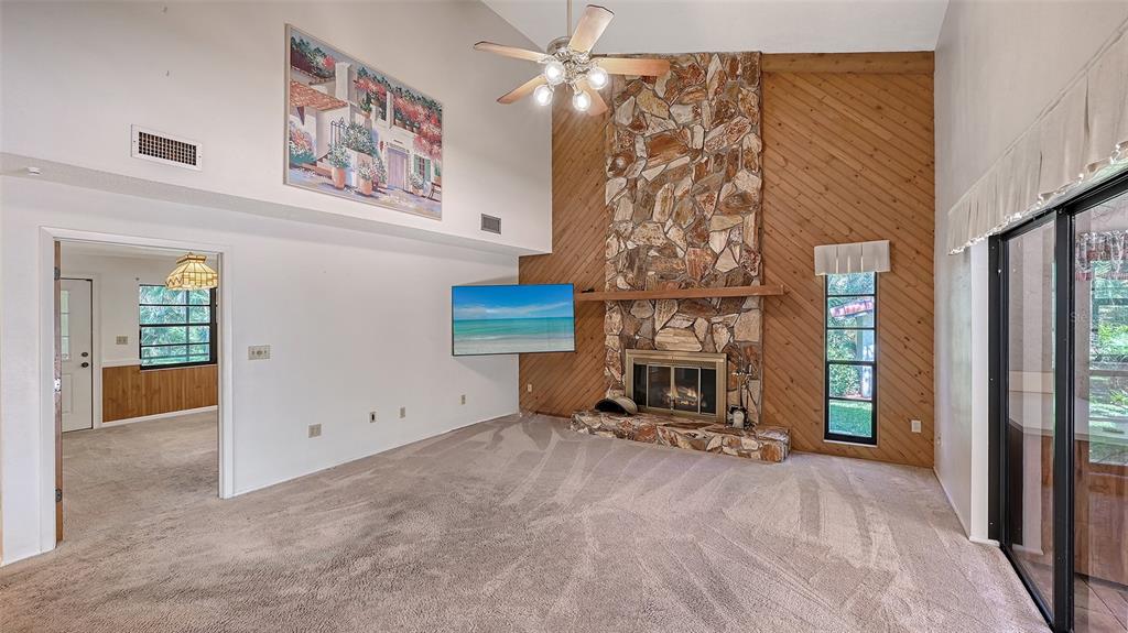 4674 Hidden River Road Sarasota, FL 34240 - Photo 13 of 46 a view of a livingroom with furniture and a fireplace