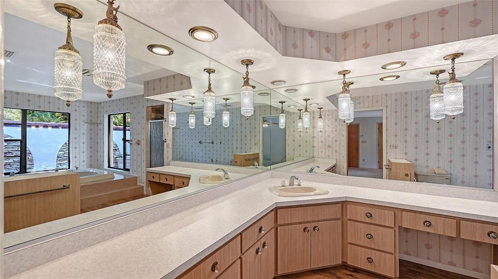 4674 Hidden River Road Sarasota, FL 34240 - Photo 16 of 46 a view of a double vanity sink and a mirror