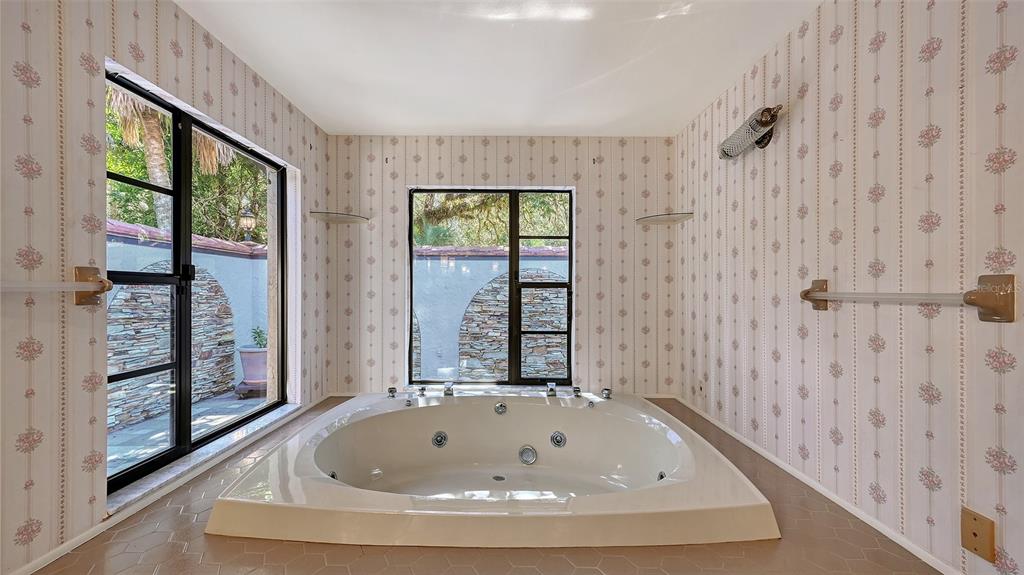 4674 Hidden River Road Sarasota, FL 34240 - Photo 17 of 46 a bathroom with bathtub and window