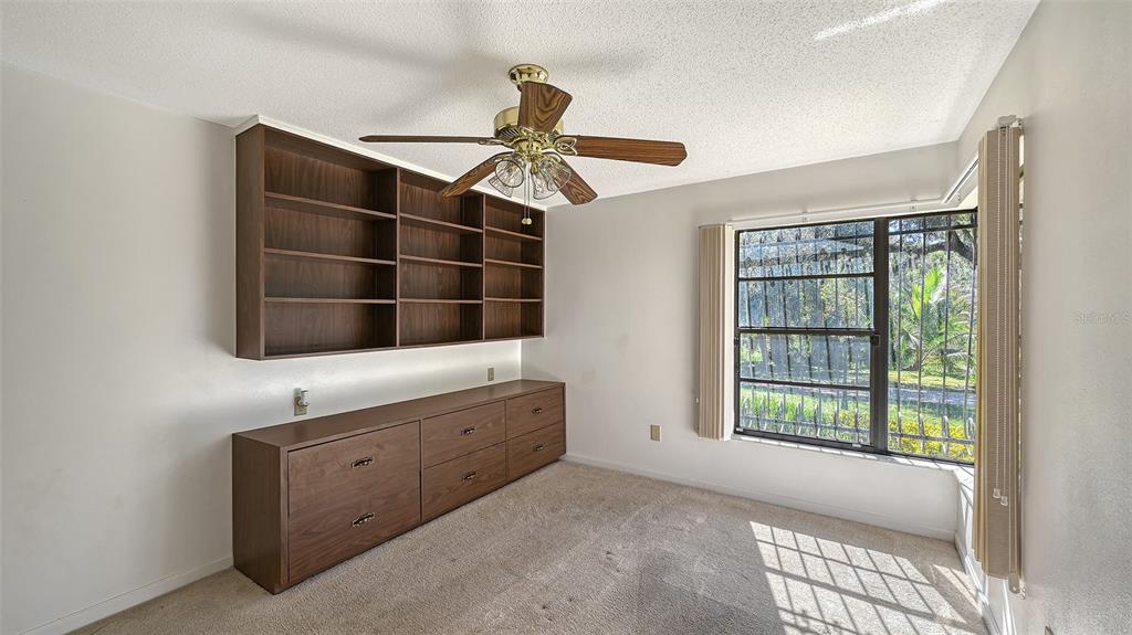 4674 Hidden River Road Sarasota, FL 34240 - Photo 19 of 46 a room with a bed and a window