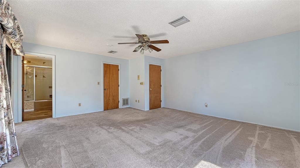 4674 Hidden River Road Sarasota, FL 34240 - Photo 20 of 46 a view of a room with a ceiling fan