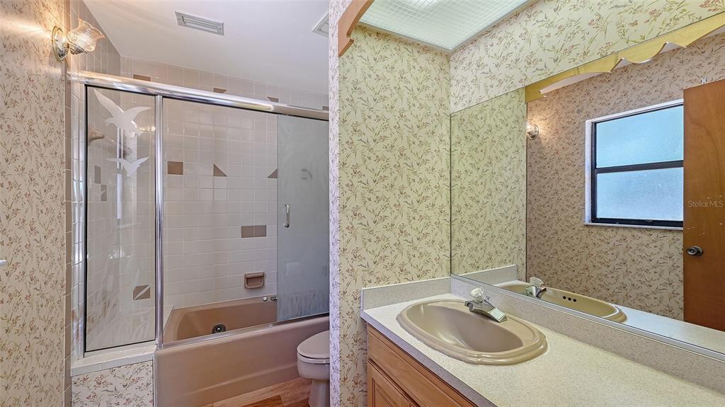 4674 Hidden River Road Sarasota, FL 34240 - Photo 21 of 46 a bathroom with a sink granite tub toilet and shower
