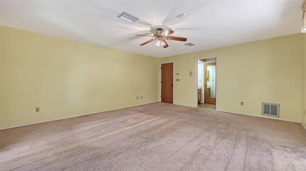 4674 Hidden River Road Sarasota, FL 34240 - Photo 22 of 46 a view of an empty room and chandelier fan