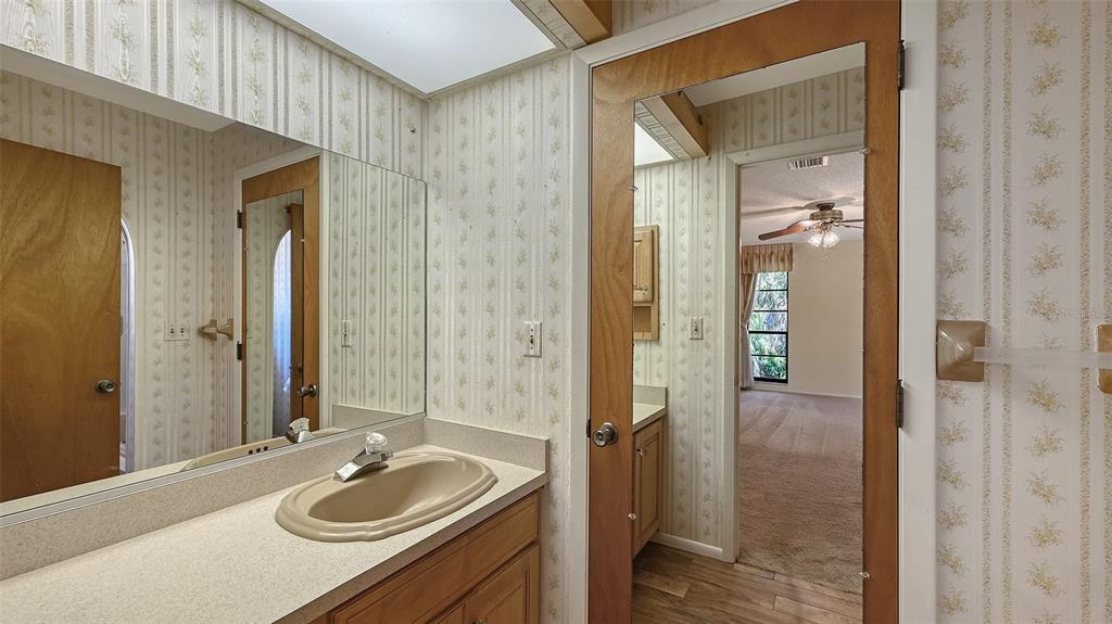 4674 Hidden River Road Sarasota, FL 34240 - Photo 23 of 46 a bathroom with a sink vanity granite tub and shower
