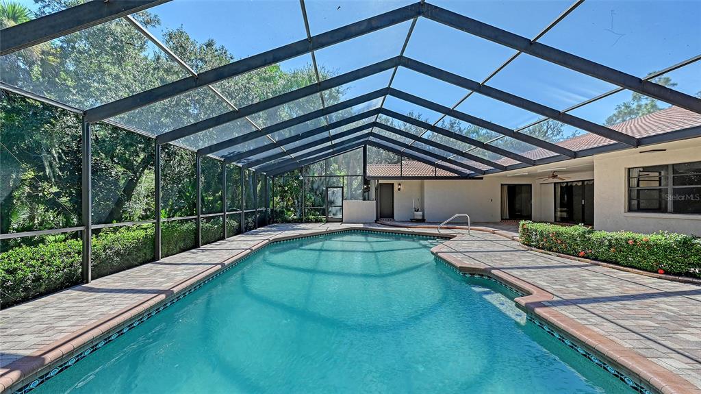 4674 Hidden River Road Sarasota, FL 34240 - Photo 26 of 46 a view of a house with a swimming pool