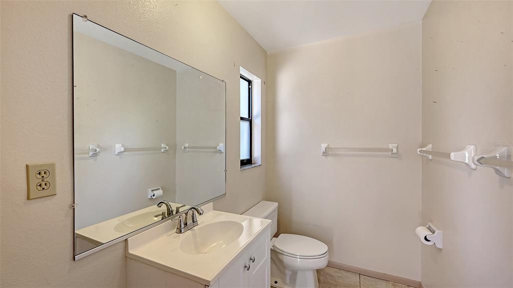 4674 Hidden River Road Sarasota, FL 34240 - Photo 29 of 46 a bathroom with a sink toilet and a mirror