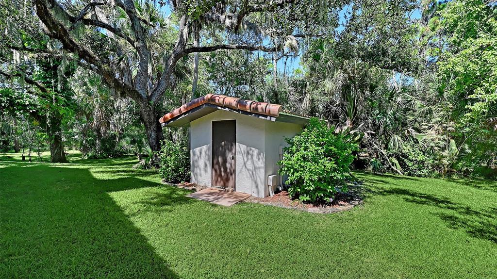 4674 Hidden River Road Sarasota, FL 34240 - Photo 30 of 46 a front view of a house with garden