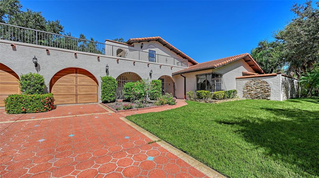 4674 Hidden River Road Sarasota, FL 34240 - Photo 3 of 46 a front view of a house with garden