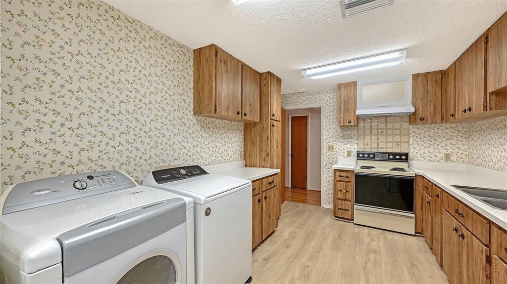 4674 Hidden River Road Sarasota, FL 34240 - Photo 32 of 46 a kitchen with a stove and a sink