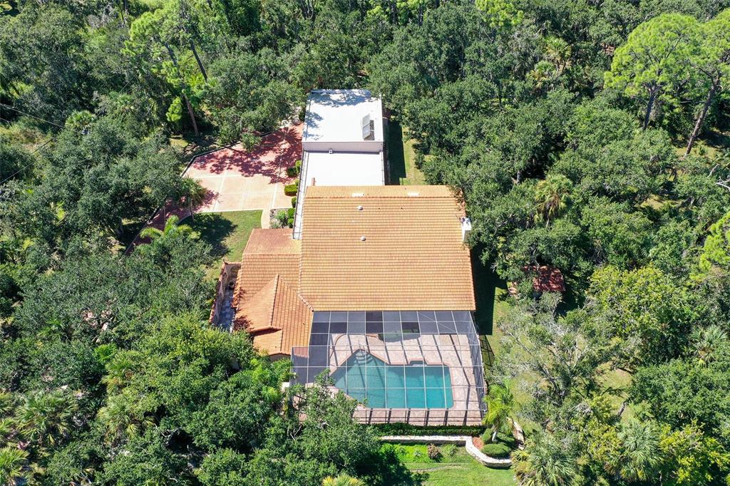 4674 Hidden River Road Sarasota, FL 34240 - Photo 36 of 46 an aerial view of a house with a yard and large trees