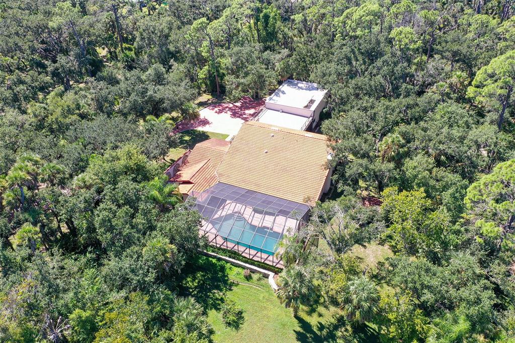 4674 Hidden River Road Sarasota, FL 34240 - Photo 38 of 46 an aerial view of a house with outdoor space and trees all around