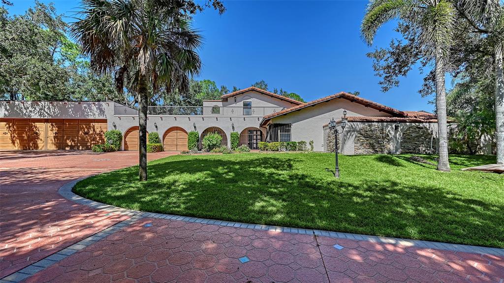 4674 Hidden River Road Sarasota, FL 34240 - Photo 4 of 46 a front view of a house with garden