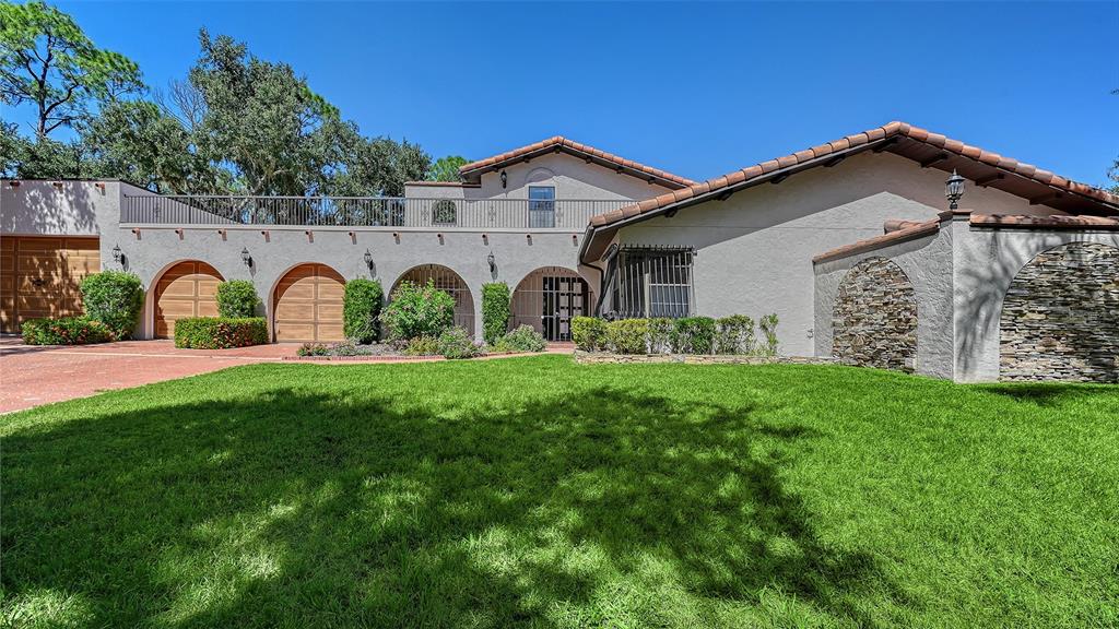 4674 Hidden River Road Sarasota, FL 34240 - Photo 45 of 46 a view of a house with backyard and a garden