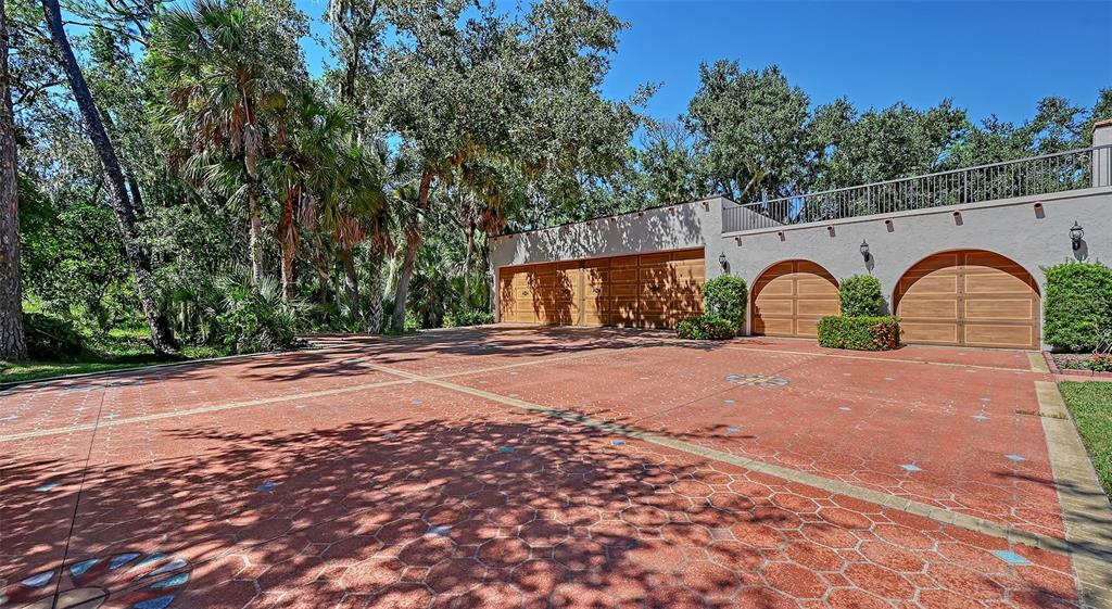 4674 Hidden River Road Sarasota, FL 34240 - Photo 5 of 46 a front view of a house with a yard and garage