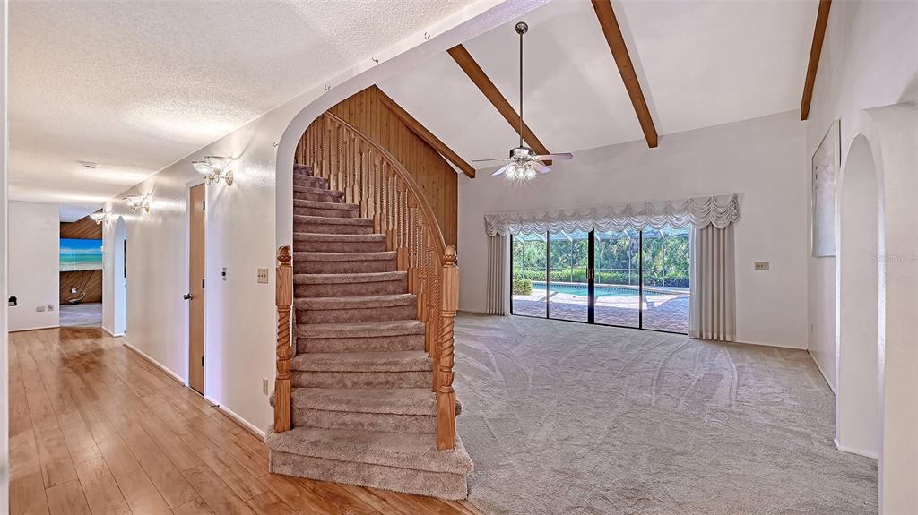 4674 Hidden River Road Sarasota, FL 34240 - Photo 6 of 46 a view of a hallway with stairs and a window