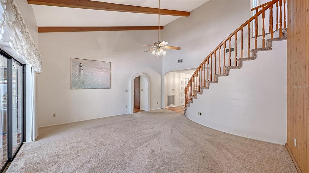 4674 Hidden River Road Sarasota, FL 34240 - Photo 7 of 46 a view of a hallway with staircase