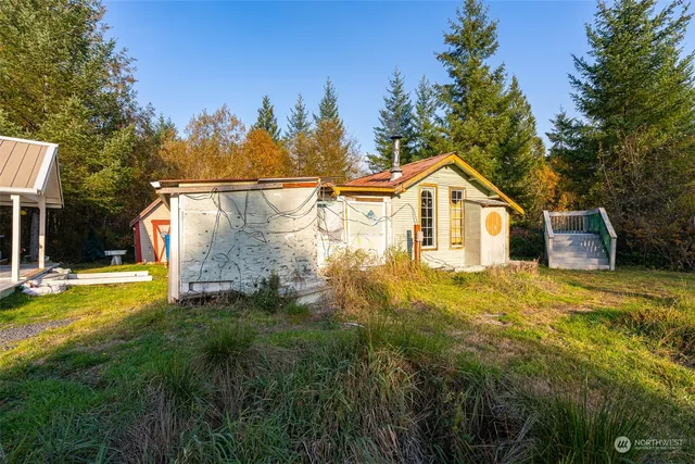 a view of a house with backyard outdoor seating area and garden