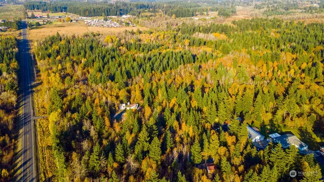 a view of a house with pool and chairs