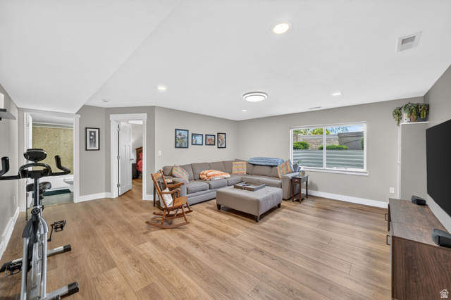 7872 Farm House Lane Midvale, UT 84047 - Photo 26 of 39 Spacious room featuring wood-finish flooring, recessed lighting, and a window with natural light