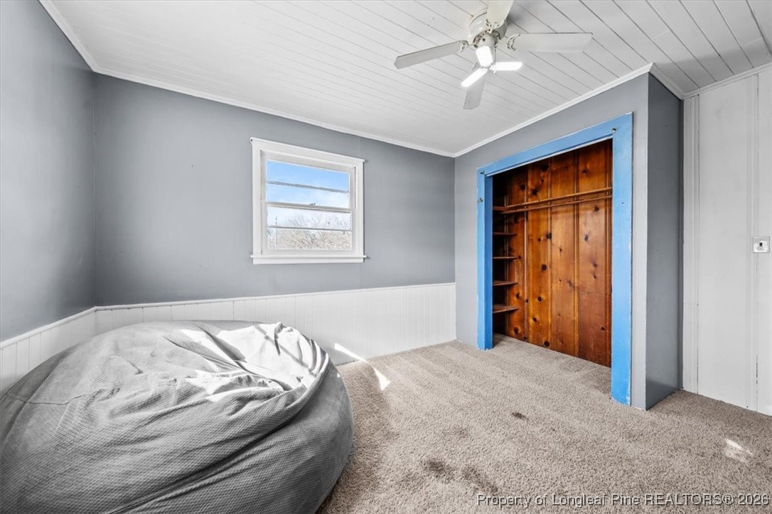 101 North Rockingham Street Robbins, NC 27325 - Photo 29 of 32 a bedroom with a bed and a chandelier