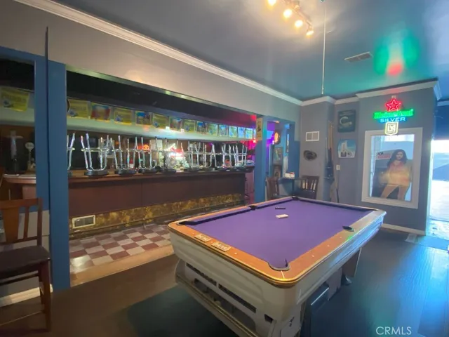 a room with pool table and a rug