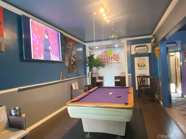 a room with pool table and windows