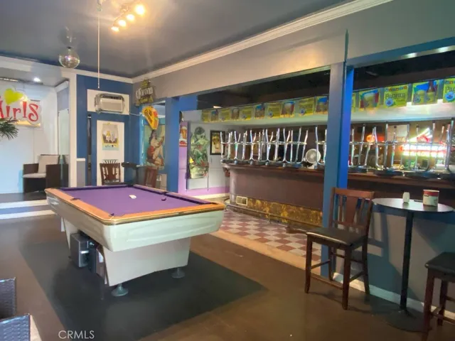 a room with pool table table tennis table and windows