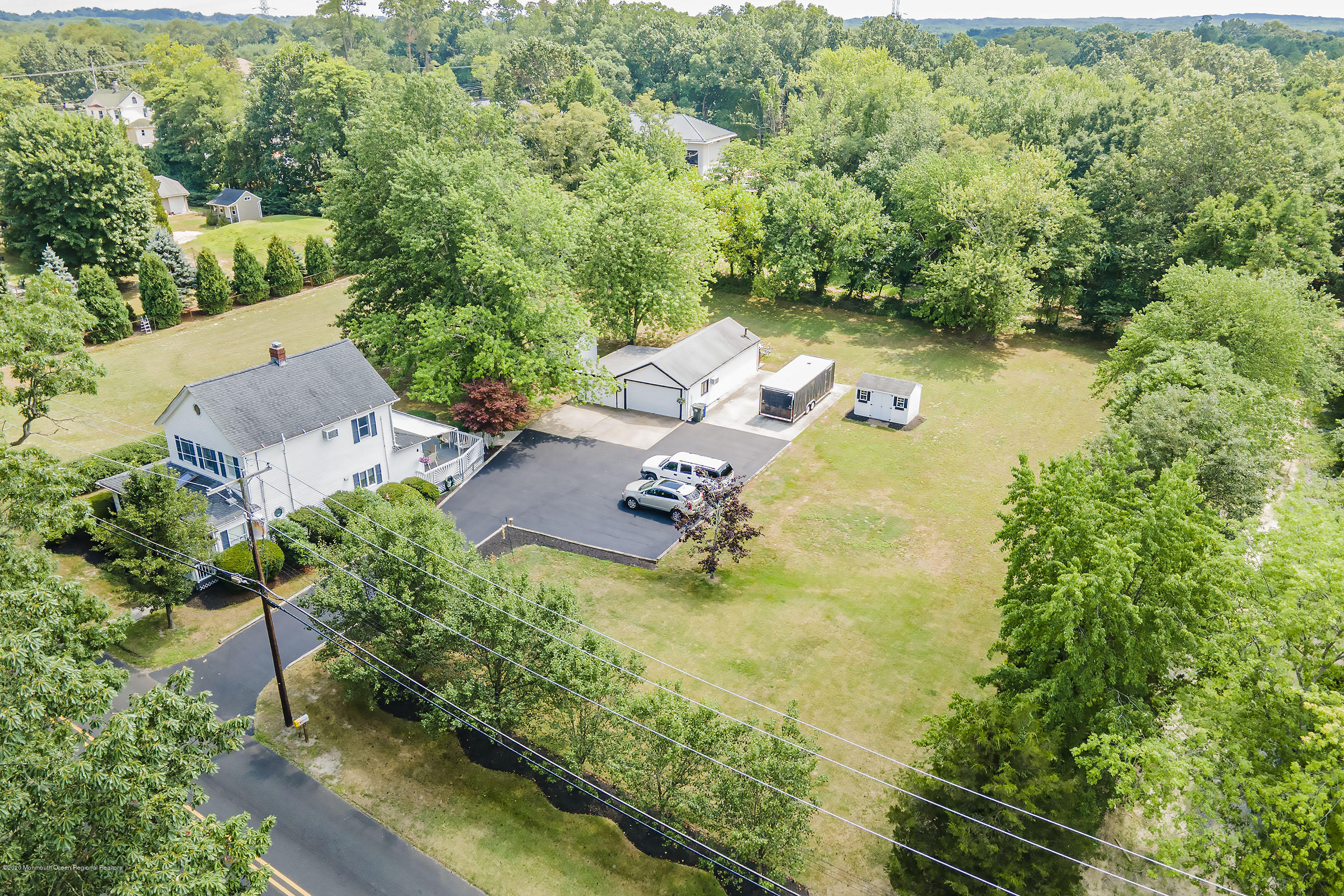 7 Wooleytown Road Morganville, NJ 07751 - Photo 1 of 30 an aerial view of a house with garden space and trees all around