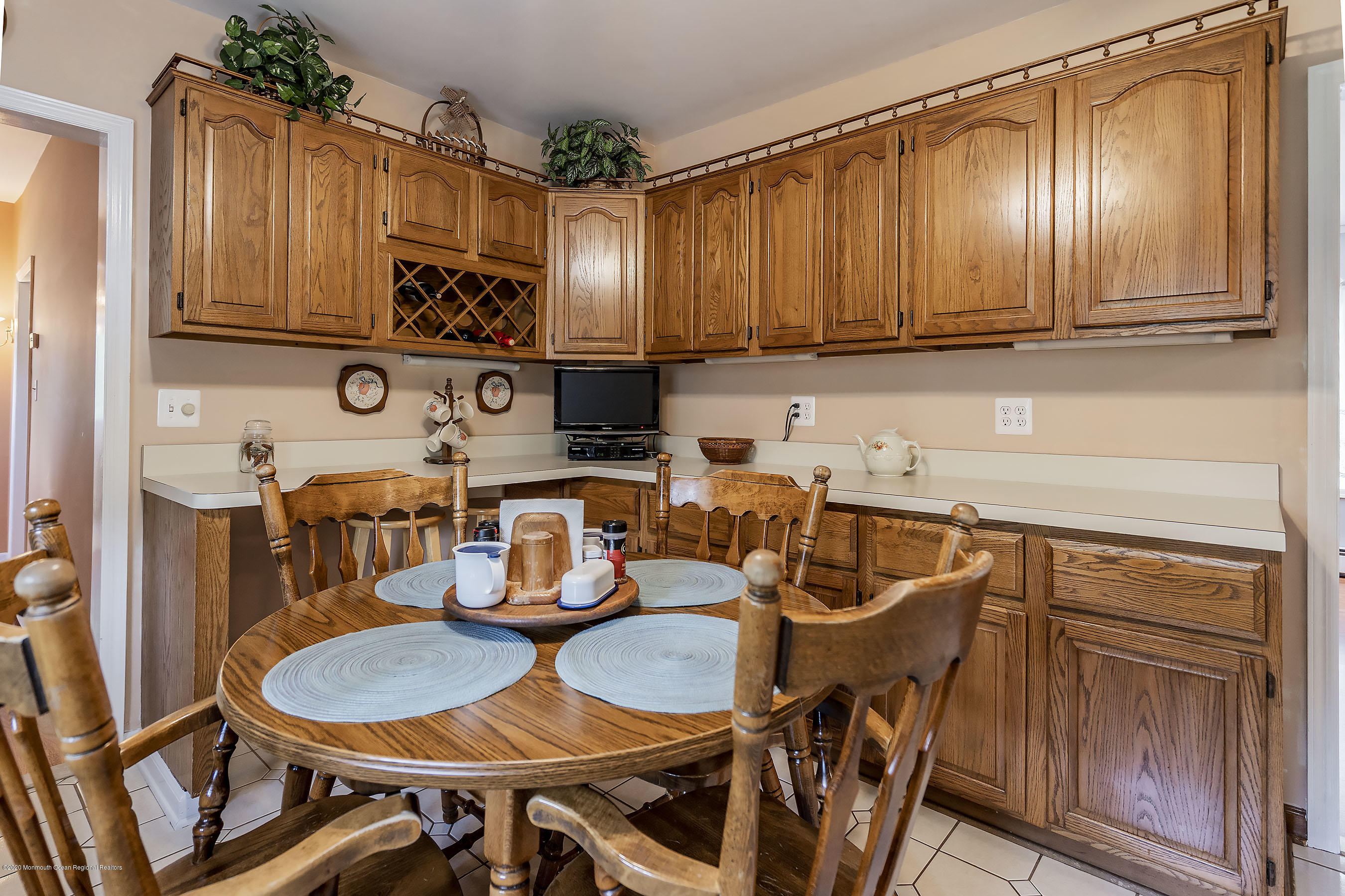 7 Wooleytown Road Morganville, NJ 07751 - Photo 11 of 30 a kitchen with stainless steel appliances granite countertop a table chairs in it and wooden floors